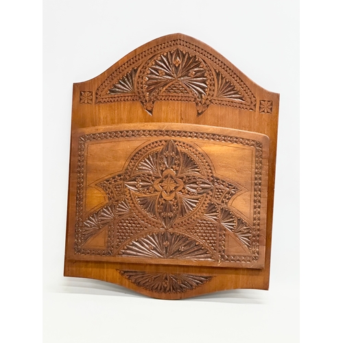 97 - A large late 19th/early 20th century chip carved birch wall hanging paper rack. Circa 1900. 34x44cm