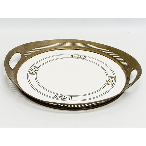 85 - An Art Nouveau ceramic tray with pierced brass frame by WMF Wächtersbach, Germany. Circa 1910. Stamp... 