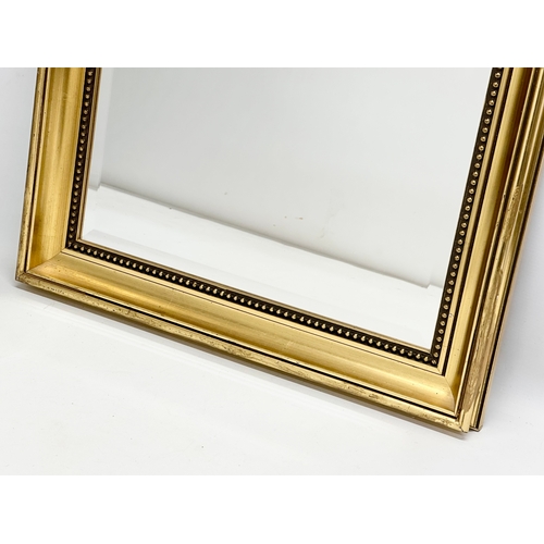 382 - A good quality Victorian style gilt framed bevelled mirror. 54x77cm