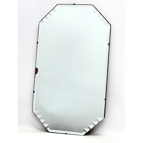 381 - A 1930’s Art Deco bevelled mirror. 38x66.5cm