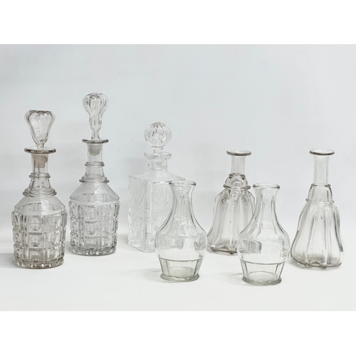 158 - A collection of early and mid 20th century decanters. A pair of tall early 20th century Georgian sty... 