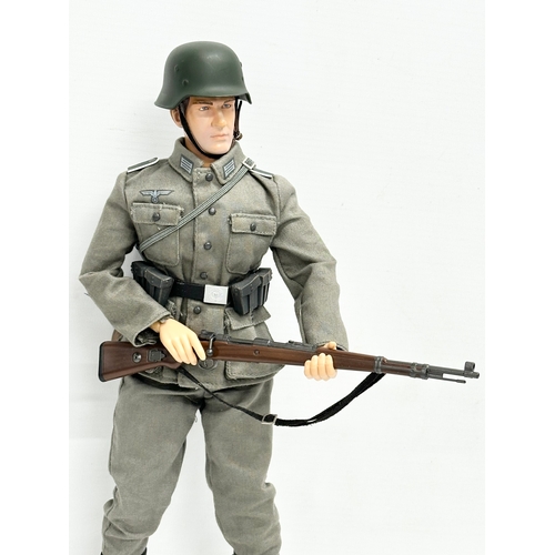 547 - A Dragon Models LTD WWII German infantry action figure. 32cm