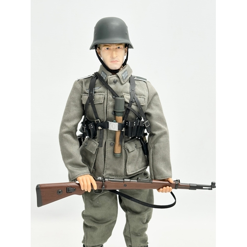 548 - A Dragon Models LTD WWII German infantry action figure. 31cm