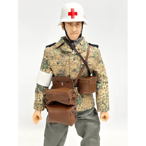 550 - A Dragon Models LTD WWII German Medic action figure. 31cm