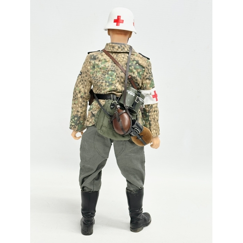 550 - A Dragon Models LTD WWII German Medic action figure. 31cm