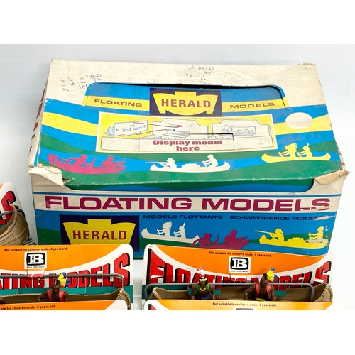 561 - A vintage Britains Herald Floating Models 14 Indian Canoes with original box.