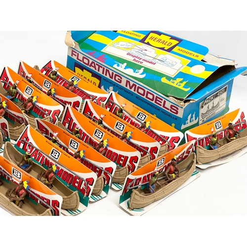 562 - A vintage Britains Herald Floating Models 14 Indian Canoes with original box.