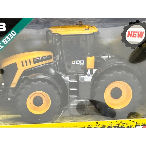 613 - A new Britains JCB Fastrac 8330 tractor with box. 25x13x16cm