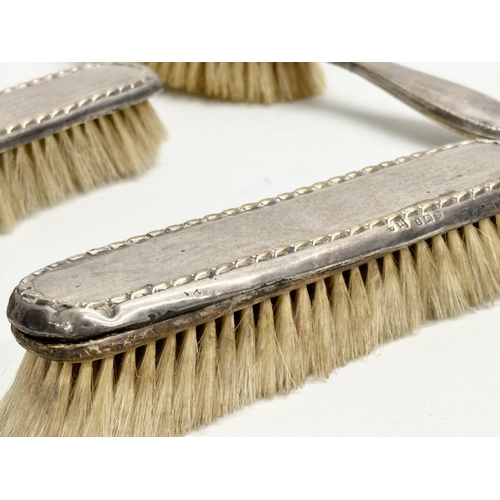 440 - 3 silver vanity brushes. A pair of early 20th century Boots Pure Drug Company silver vanity brushes,... 