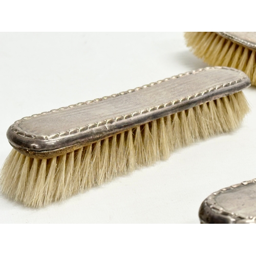 440 - 3 silver vanity brushes. A pair of early 20th century Boots Pure Drug Company silver vanity brushes,... 