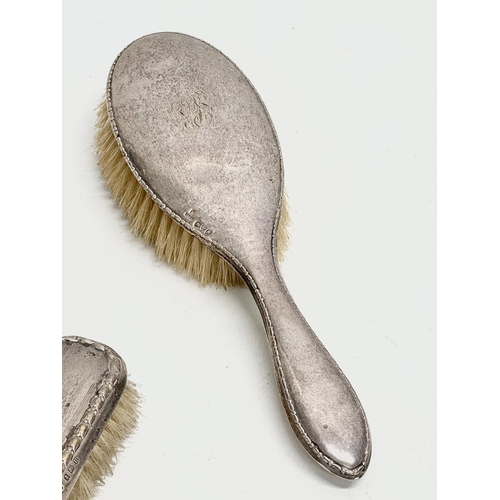 440 - 3 silver vanity brushes. A pair of early 20th century Boots Pure Drug Company silver vanity brushes,... 