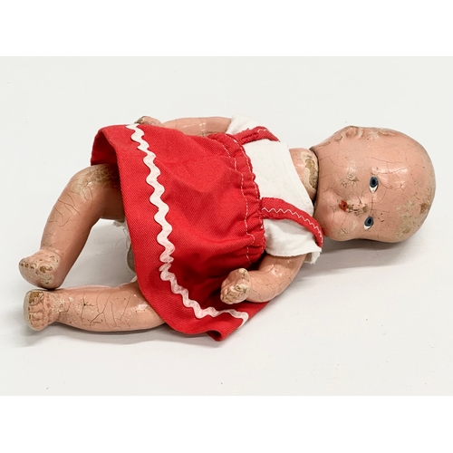 532 - An early 20th century doll. 26cm