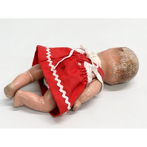 532 - An early 20th century doll. 26cm