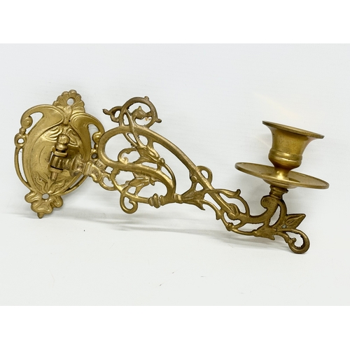 362 - A pair of early 20th century ornate brass wall bracket candleholders. 22cm