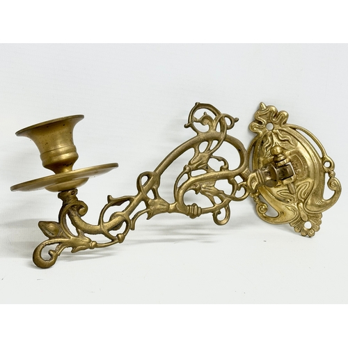 362 - A pair of early 20th century ornate brass wall bracket candleholders. 22cm