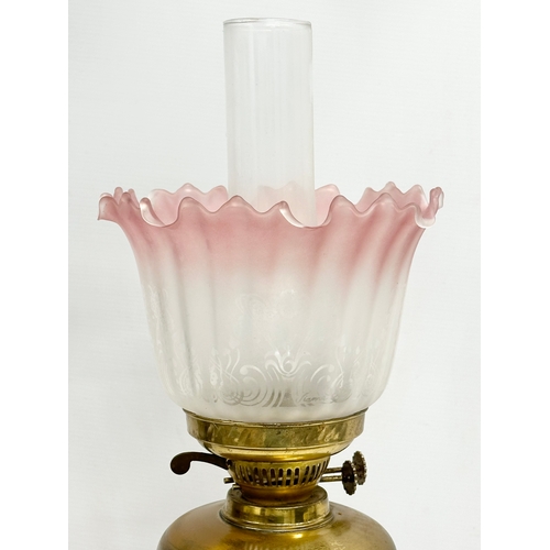 360 - A large early 20th century brass electrified oil lamp with glass shade. 61cm