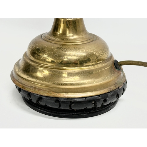 360 - A large early 20th century brass electrified oil lamp with glass shade. 61cm