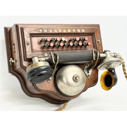 358 - An early 20th century wall mounted telephone. British Manufacturer. 26x19x16cm