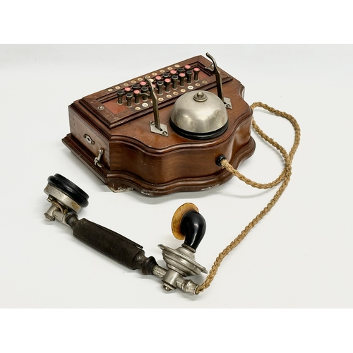 358 - An early 20th century wall mounted telephone. British Manufacturer. 26x19x16cm