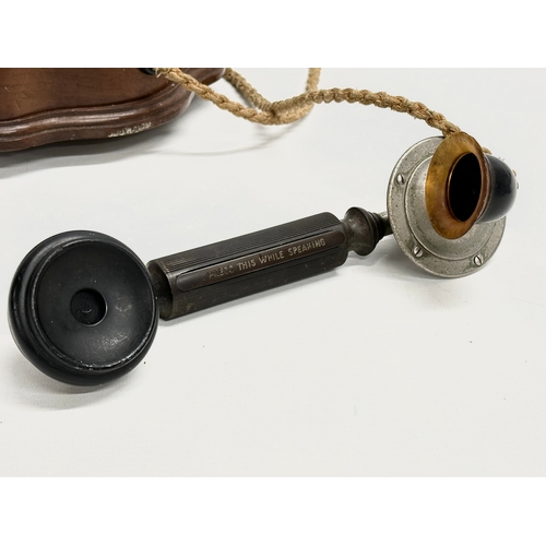 358 - An early 20th century wall mounted telephone. British Manufacturer. 26x19x16cm