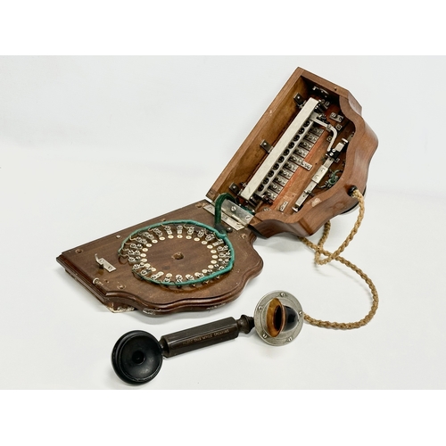 358 - An early 20th century wall mounted telephone. British Manufacturer. 26x19x16cm