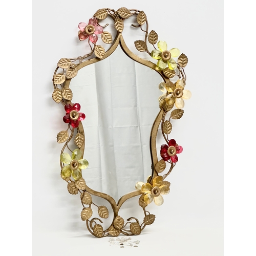 302 - A 1950’s gilt wrought iron framed mirror with coloured cut glass flowers. 36x57cm