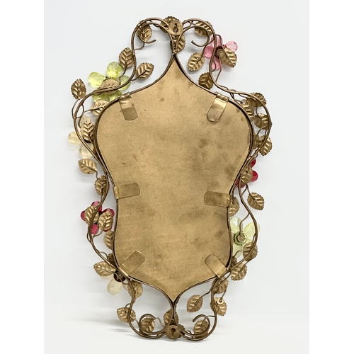 302 - A 1950’s gilt wrought iron framed mirror with coloured cut glass flowers. 36x57cm