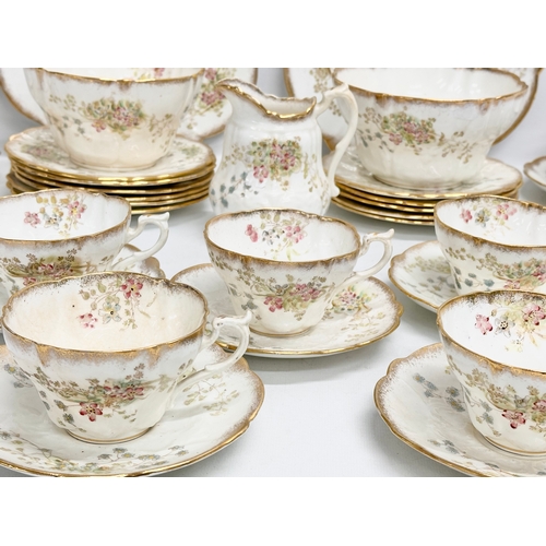 348 - A 34 piece late 19th/early 20th century gilt and wild flower tea service. Circa 1900.