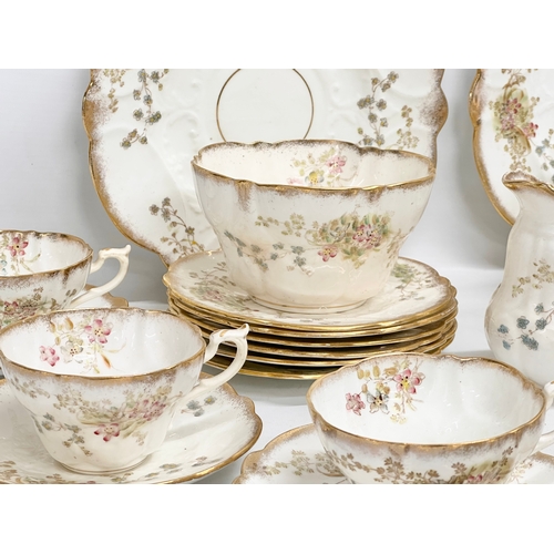 348 - A 34 piece late 19th/early 20th century gilt and wild flower tea service. Circa 1900.