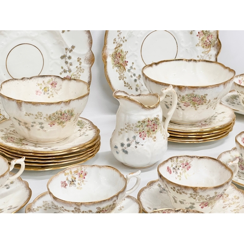 348 - A 34 piece late 19th/early 20th century gilt and wild flower tea service. Circa 1900.