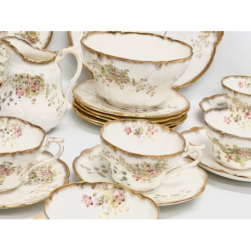 348 - A 34 piece late 19th/early 20th century gilt and wild flower tea service. Circa 1900.