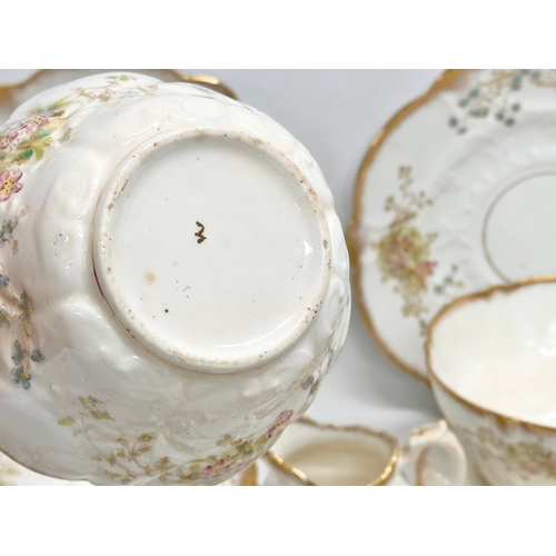 348 - A 34 piece late 19th/early 20th century gilt and wild flower tea service. Circa 1900.