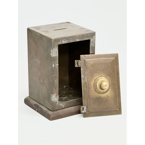 169 - A late 19th/early 20th century brass money bank safe. 12.5x12x17cm