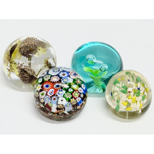 173 - A late 19th/early 20th century glass dump paperweight and 3 others. A vintage millefiori paperweight... 