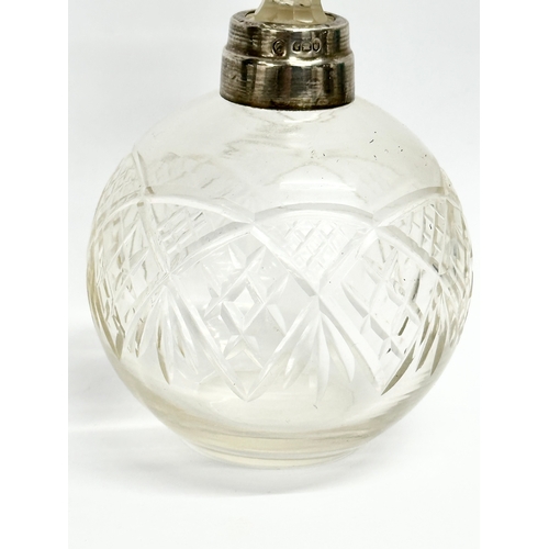 445 - An early 20th century silver mounted perfume bottle. London mark. Faded makers mark. 15cm