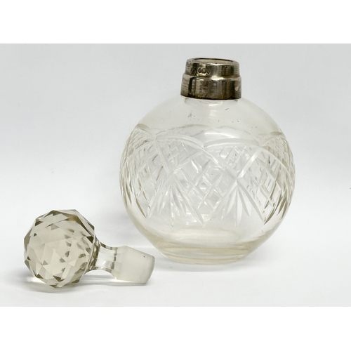 445 - An early 20th century silver mounted perfume bottle. London mark. Faded makers mark. 15cm