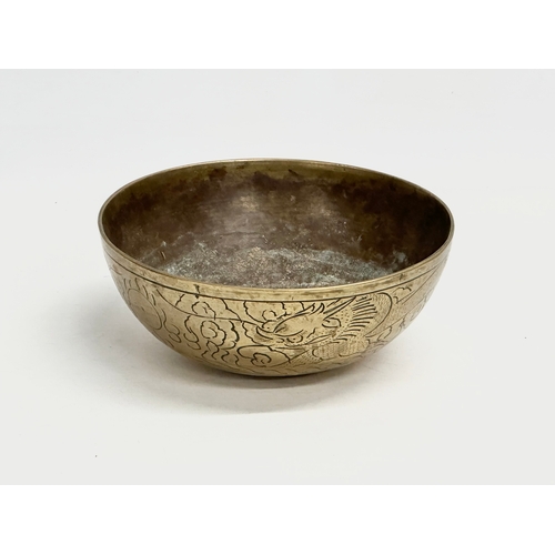 309 - An early 20th century Chinese brass bowl. 16x6.5cm