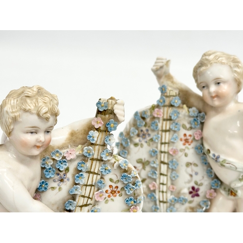 278 - Late 19th century porcelain cherubs. A pair of late 19th century cherub spill vases and a porcelain ... 