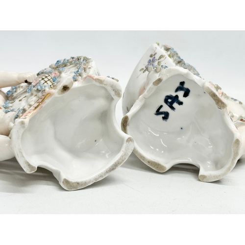 278 - Late 19th century porcelain cherubs. A pair of late 19th century cherub spill vases and a porcelain ... 