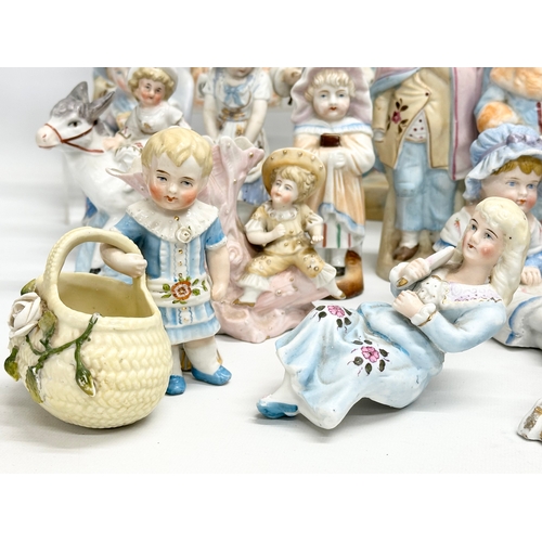 279 - A large collection of late 19th and early 20th century German Bisque figurines. Largest pair 43cm. 3... 