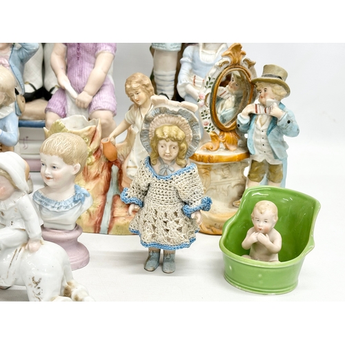 279 - A large collection of late 19th and early 20th century German Bisque figurines. Largest pair 43cm. 3... 