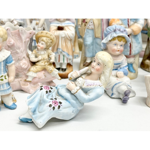 279 - A large collection of late 19th and early 20th century German Bisque figurines. Largest pair 43cm. 3... 