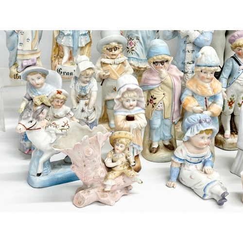 279 - A large collection of late 19th and early 20th century German Bisque figurines. Largest pair 43cm. 3... 