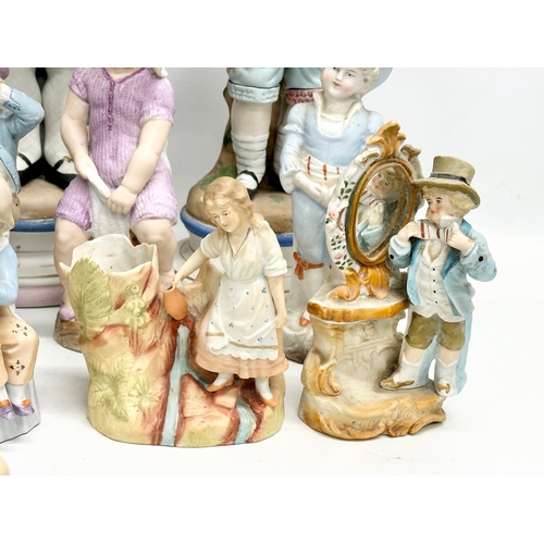 279 - A large collection of late 19th and early 20th century German Bisque figurines. Largest pair 43cm. 3... 