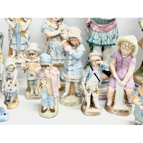 279 - A large collection of late 19th and early 20th century German Bisque figurines. Largest pair 43cm. 3... 