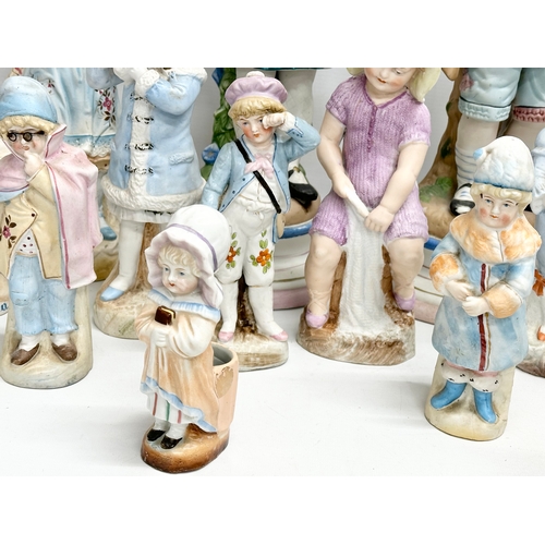 279 - A large collection of late 19th and early 20th century German Bisque figurines. Largest pair 43cm. 3... 