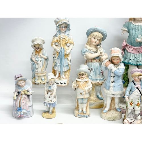 279 - A large collection of late 19th and early 20th century German Bisque figurines. Largest pair 43cm. 3... 