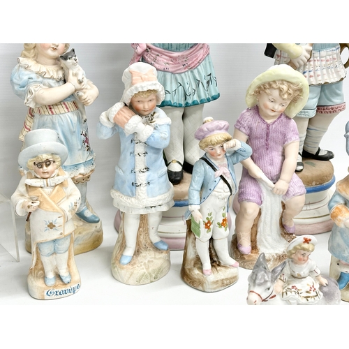 279 - A large collection of late 19th and early 20th century German Bisque figurines. Largest pair 43cm. 3... 