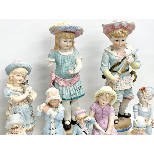 279 - A large collection of late 19th and early 20th century German Bisque figurines. Largest pair 43cm. 3... 