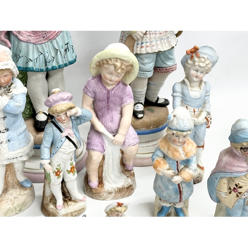 279 - A large collection of late 19th and early 20th century German Bisque figurines. Largest pair 43cm. 3... 